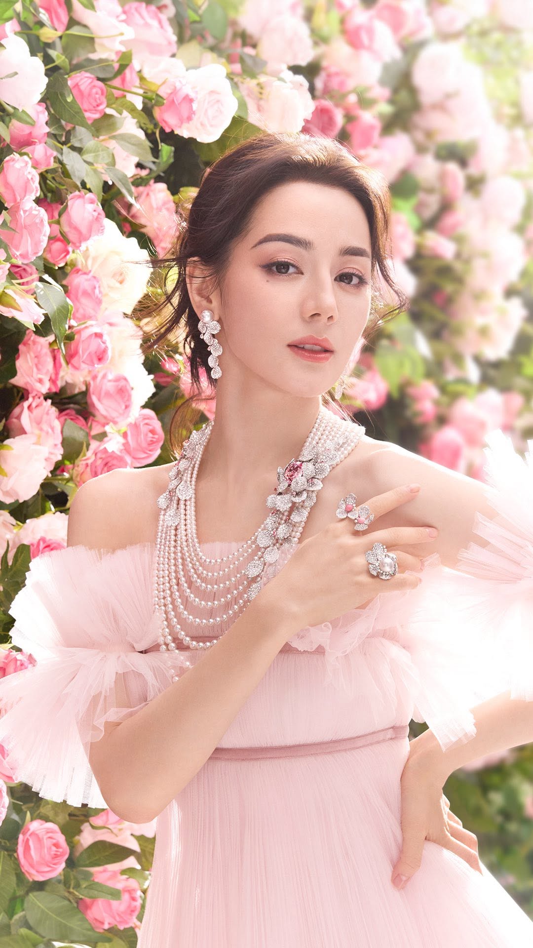 Woman in a pink dress with Mikimoto Pearls and Jewelry with a floral background