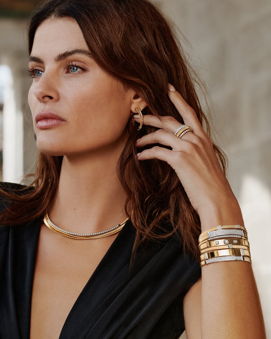 Isabeli Fontana Marco Bicego wearing gold jewelry including a necklace, bracelet, and ring.