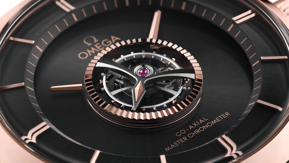 Close-up of an Omega De Ville watch with black dial and rose gold accents