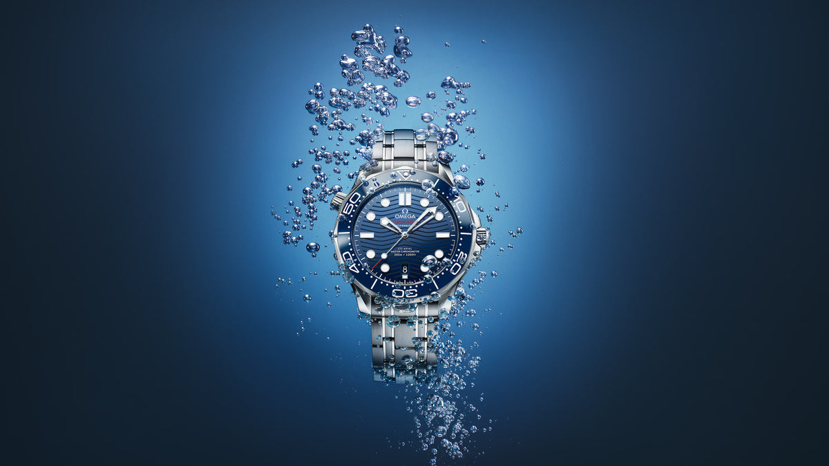 Omega Seamaster 300M Blue Dial Watch with water droplets on a blue background